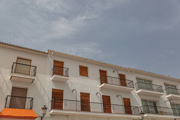 Typical facade of a white mediterranean touristic building on a sunny day