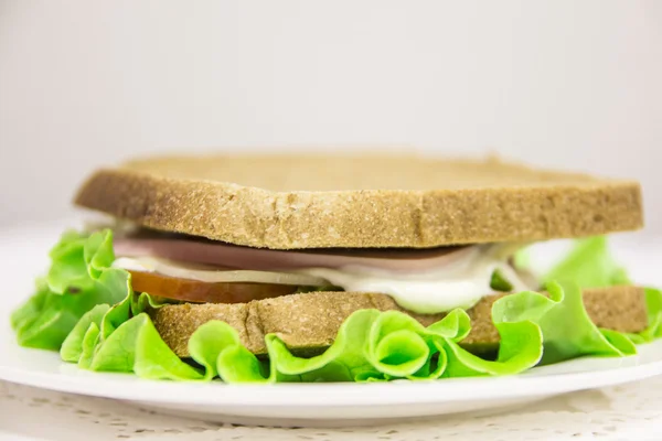 American fresh home sandwich with salami, cheese, salad and tomatoes — Stock Photo, Image