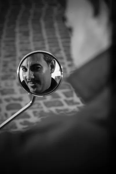 Hombre mirando en el espejo scooter — Foto de Stock