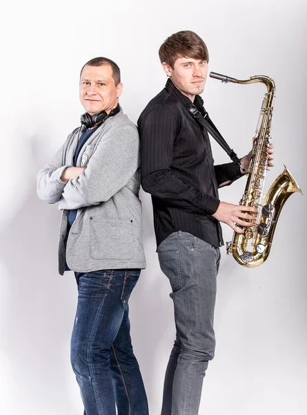 Saxophonist and DJ posing in studio — Stock Photo, Image