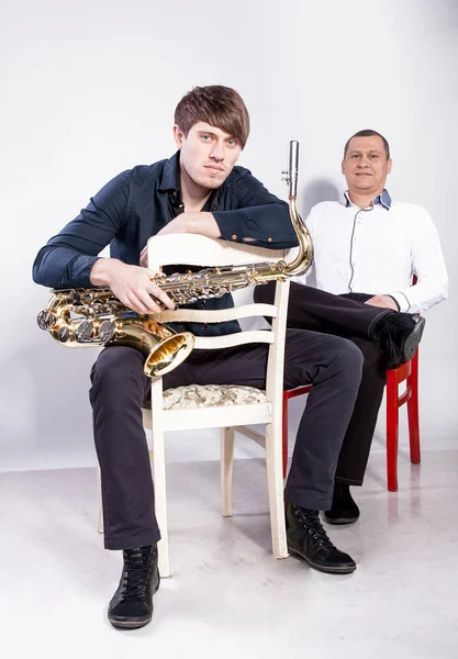 Musical duet sitting on chairs — Stock Photo, Image