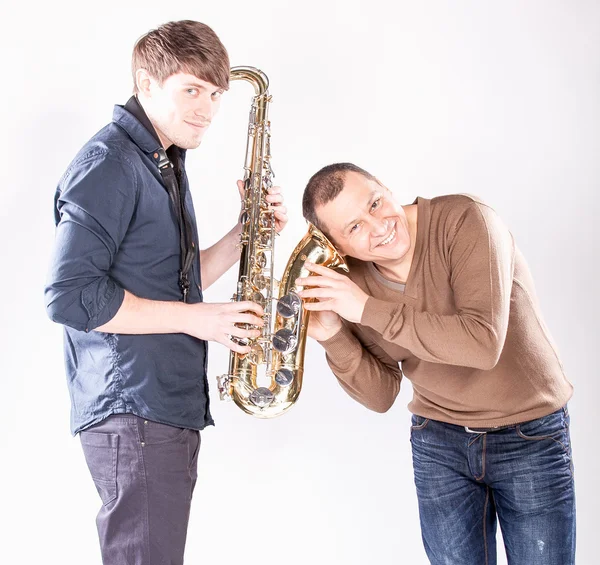 Man holding ear close saxophone — Stock Photo, Image