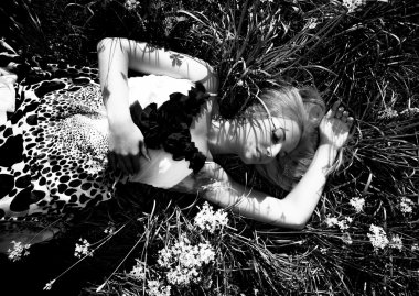 Beautiful girl lying on flowerbed