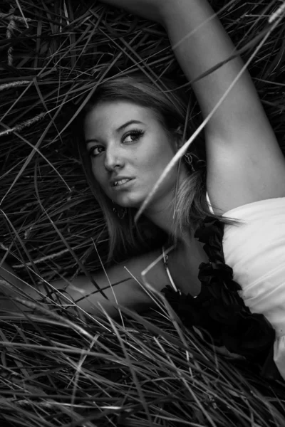 Portrait of sexy girl lying in hay — Stock Photo, Image