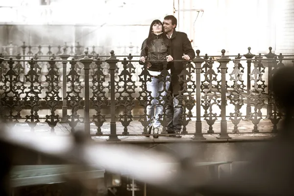 Young couple hugging in bridge — Stock Photo, Image