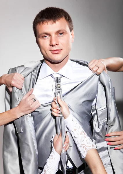 Handsome man with hands taking off his clothes — Stock Photo, Image