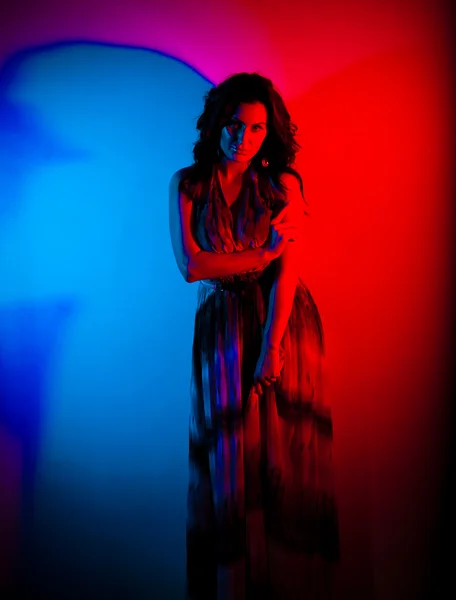 Girl in red and blue light — Stock Photo, Image