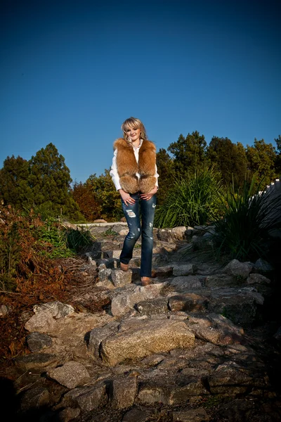 Beautiful girl walking on paving road — Stock Photo, Image