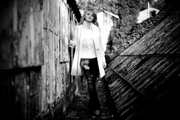 Sexy girl walking near old abandoned greenhouse — Stock Photo, Image