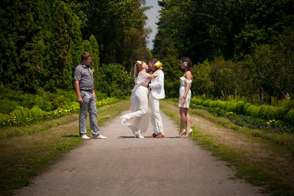 这对新婚的夫妇拥抱在公园的道路上 — 图库照片