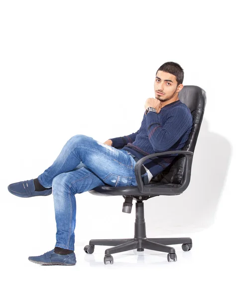 Handsome man in casual clothes sitting on chair — Stock Photo, Image