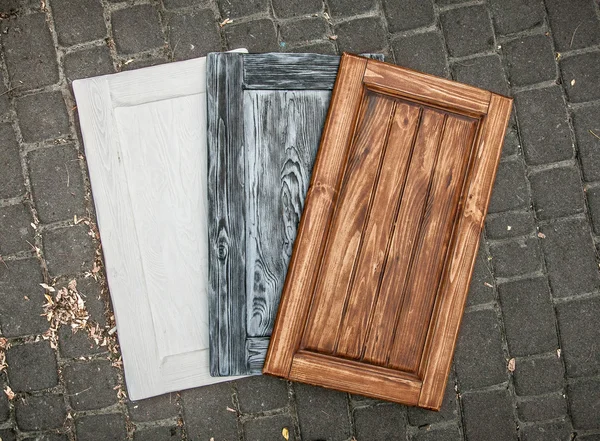 Three colored wooden doors lying on paving road — Stock Photo, Image