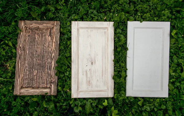 Wooden doors lying on grass — Stock Photo, Image