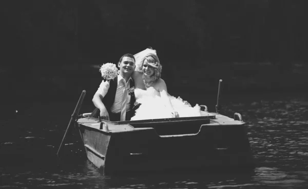 Casal recém-casado cavalgando em barco a remo — Fotografia de Stock