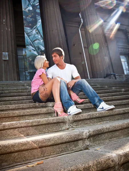 Couple in love hugging on stairs against old columns — Stock Photo, Image