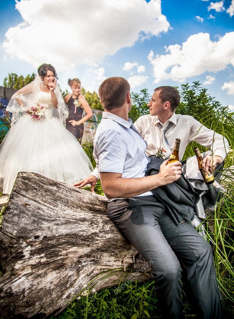 Groom Drinking Beer With Friend While Bride Arguing Stock Photo