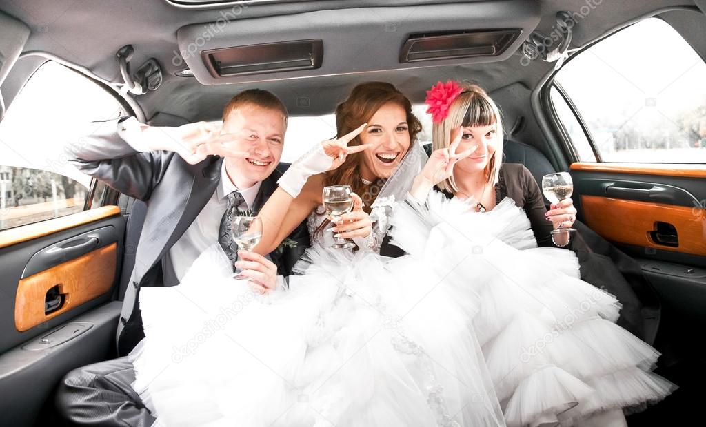 Couple having fun with friends in limousine