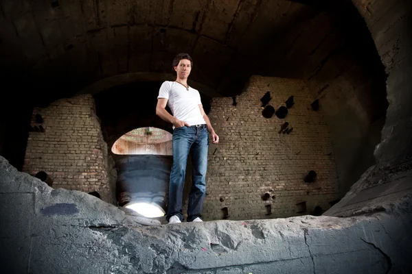 Man standing in ruined abandoned building — Stock Photo, Image