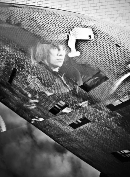 Portrait through window with reflected buildings of man in car — Stock Photo, Image