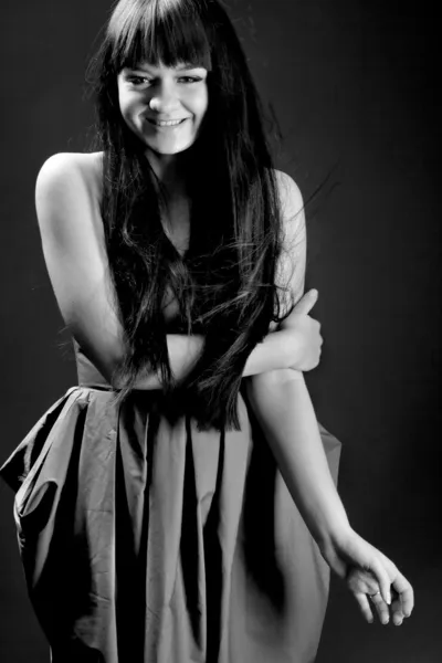 Brunette woman laughing while holding hand on shoulder — Stock Photo, Image