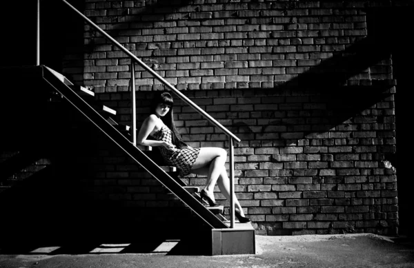 Photo of sexy woman lying on stairs at backyard of building — Stock Photo, Image