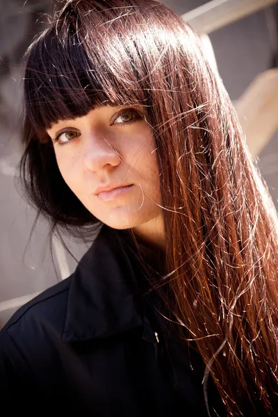 Beautiful brunette girl with long hair posing outdoor — Stock Photo, Image