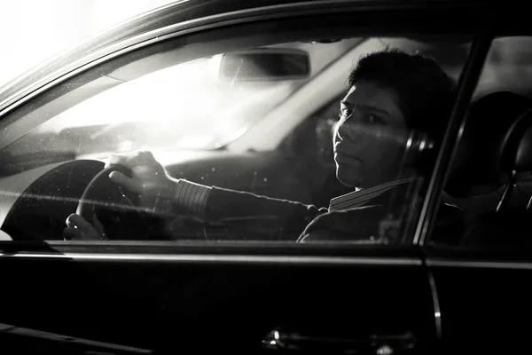 Portrait of handsome driver looking through side window — Stock Photo, Image