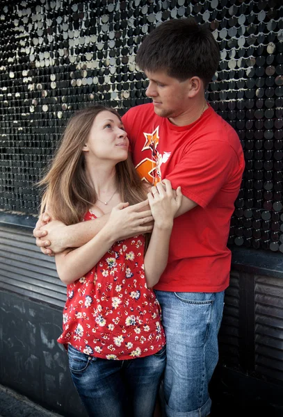 Casal de estudantes abraçando na rua contra a parede — Fotografia de Stock