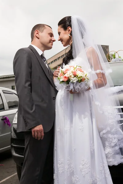 Casamento recém-casado em pé na frente de cada um no estacionamento do carro — Fotografia de Stock