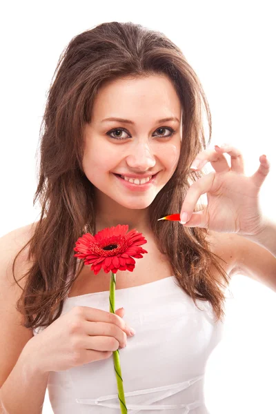 Portrait of brunette girl pulling petal on red flower — Stock Photo, Image