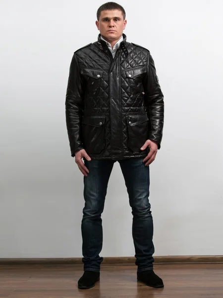 Isolated portrait of handsome man in leather coat and jeans — Stock Photo, Image