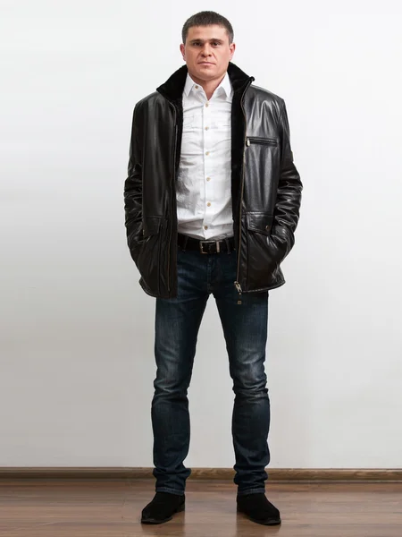 Man in white shirt wearing unzipped warm leather coat — Stock Photo, Image