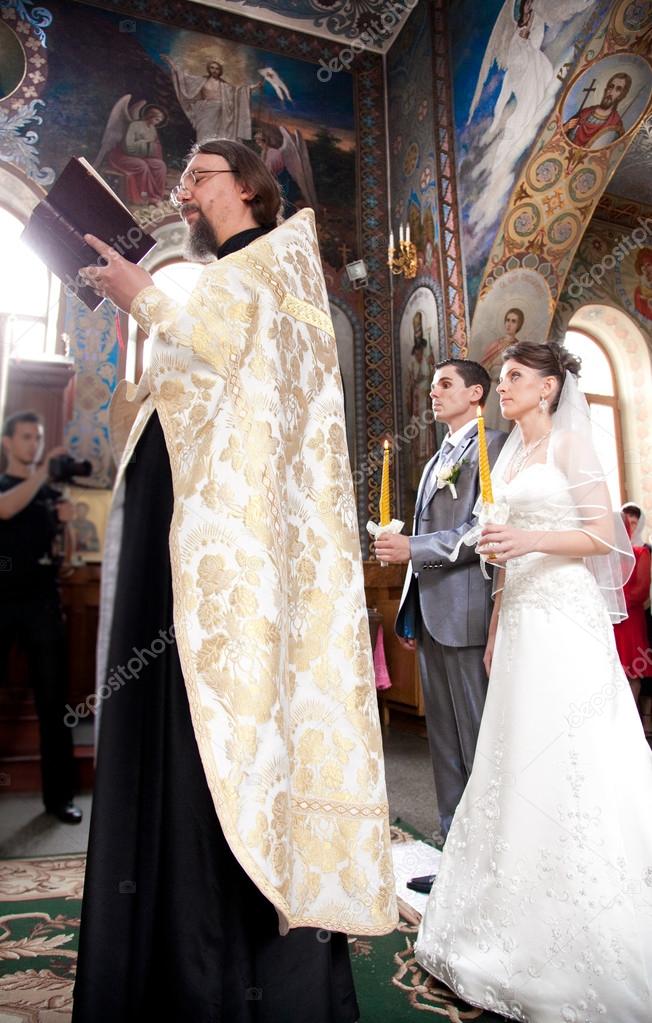 Couple getting married in church by orthodox priest
