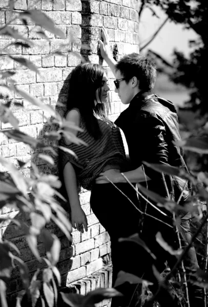 Photo of couple in love hugging against old brick wall — Stock Photo, Image