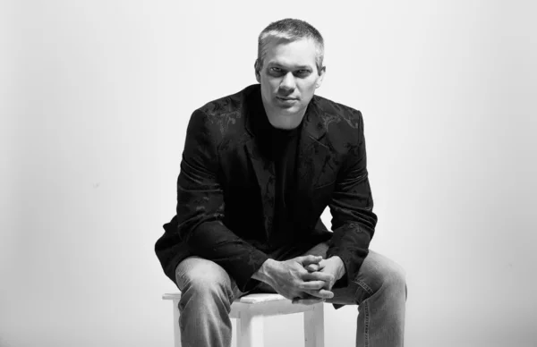 Portret elegancki mężczyzna siedzi na krześle w studio — Zdjęcie stockowe