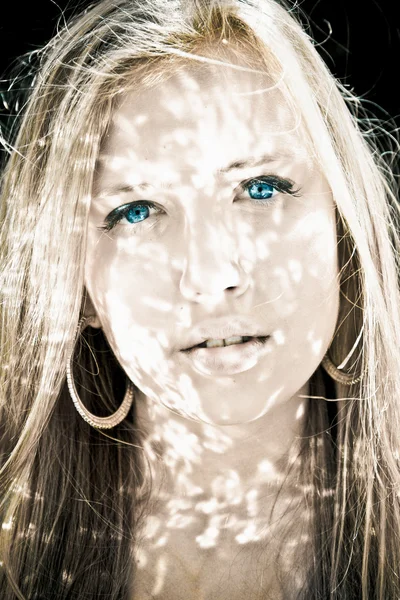 Tonas porträtt av blond kvinna med reflektion från vatten på ansikte — Stockfoto