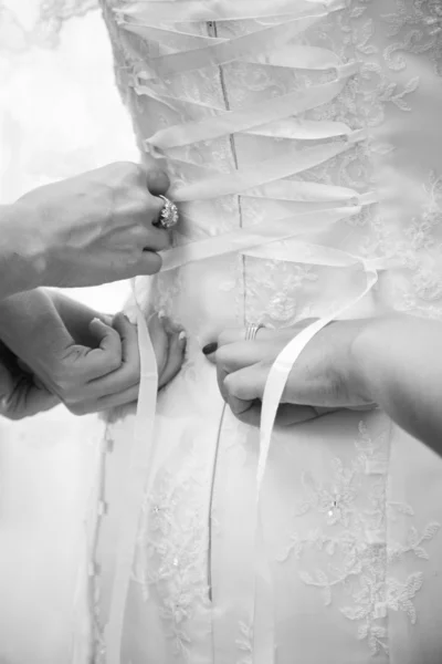 Closeup shot two women tying bridal corset — Stock Photo, Image