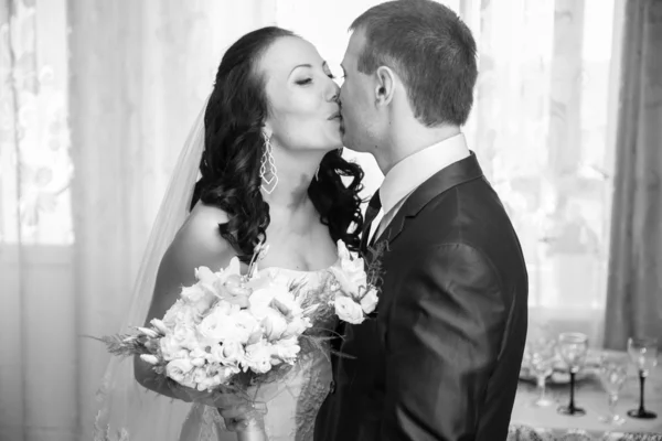 Portrait of bride and groom kissing at home — Stock Photo, Image
