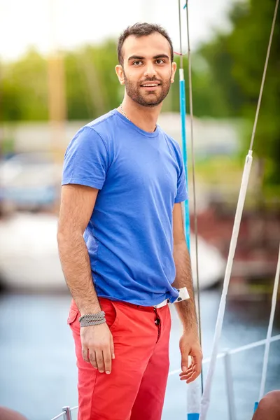 Stylish latin man sailing on yacht — Stock Photo, Image