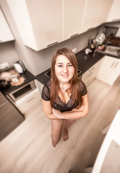 Woman on kitchen smiling at camera and looking up — Stock Photo, Image