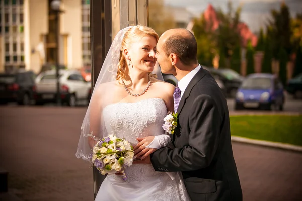 Mid-aged bride and groom standing on street — Stock Photo, Image