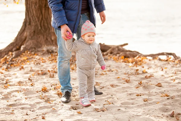 Father holding hands with small daughter on beach — Stock Photo, Image