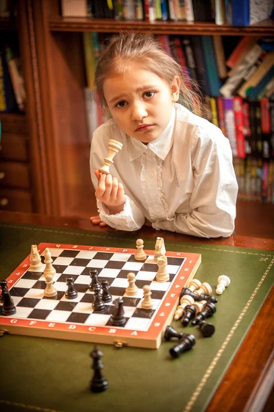 Girl thinking on move at chess — Stock Photo, Image