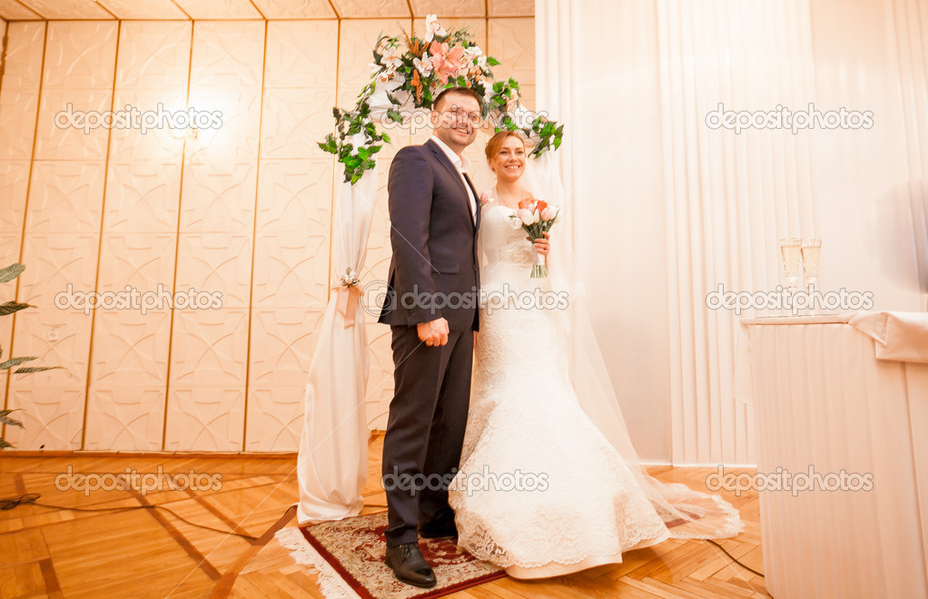 Bride and groom standing at registry office