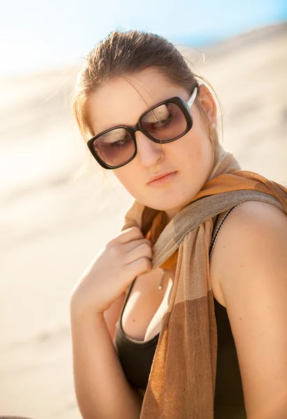 Woman in sunglasses and scarf at desert — Stock Photo, Image