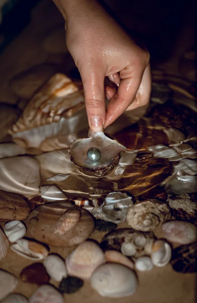 Photo of woman searching for pearls at night — Stock Photo, Image