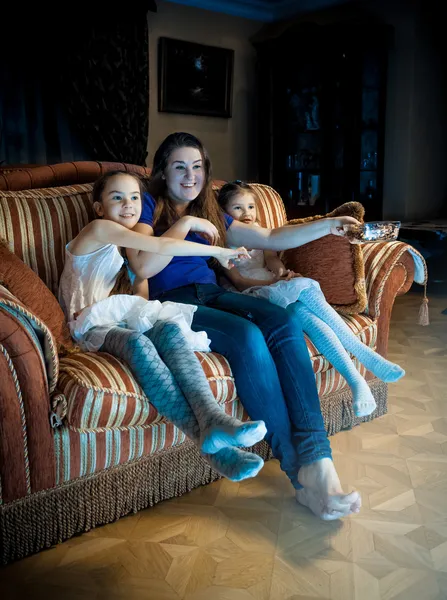 Familia con niños viendo la televisión al atardecer — Foto de Stock