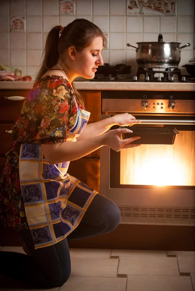 Photo of housewife cooking cookies in oven — Stock Photo, Image