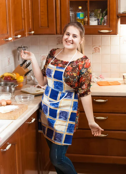 Beautiful smiling housewife in apron — Stock Photo, Image