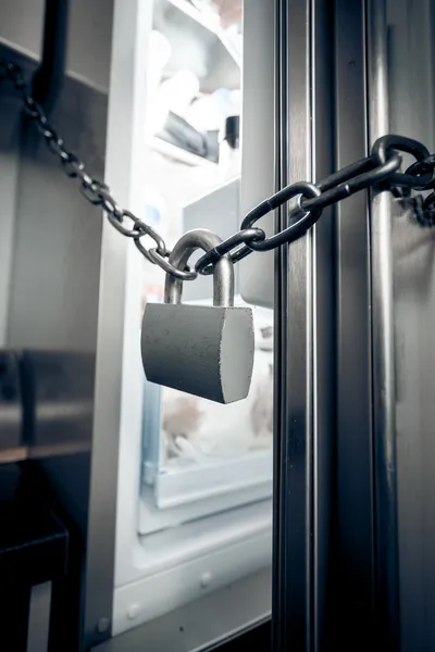 Photo of metal lock hanging on refrigerator door — Stock Photo, Image